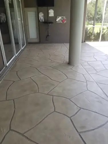 Ashlar-stamped concrete patio under a covered lanai column